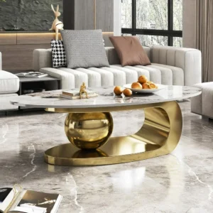 Modern oval stone coffee table with a polished faux marble top and an abstract gold metal base, from Verra Luxe Home, featuring a bold gold curved support