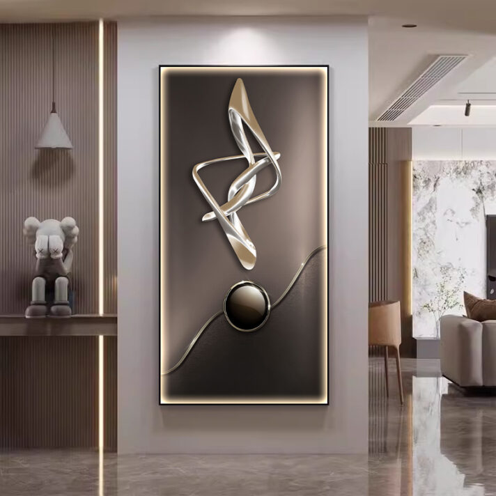 Verra Luxe Home abstract wall lamp artwork with intertwined gold and silver ribbons above a glossy black circular base, framed by a soft glowing border for elegant modern decor