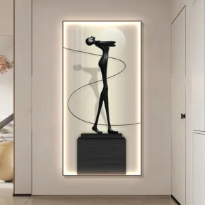 Black abstract humanoid sculpture with a slender form and curling ribbon, perched on a dark pedestal, set in a softly illuminated frame for Verra Luxe Home’s modern wall art.
