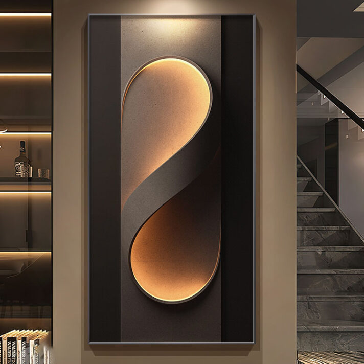 Gold curved abstract sculpture on a dark panel wall, illuminated by warm lighting in a modern luxury interior with marble floor and glass staircase.