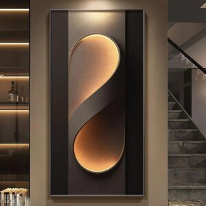 Verra Luxe Home wall light with a gold curved shade inside a dark rectangular frame, emitting a warm ambient glow for contemporary interiors