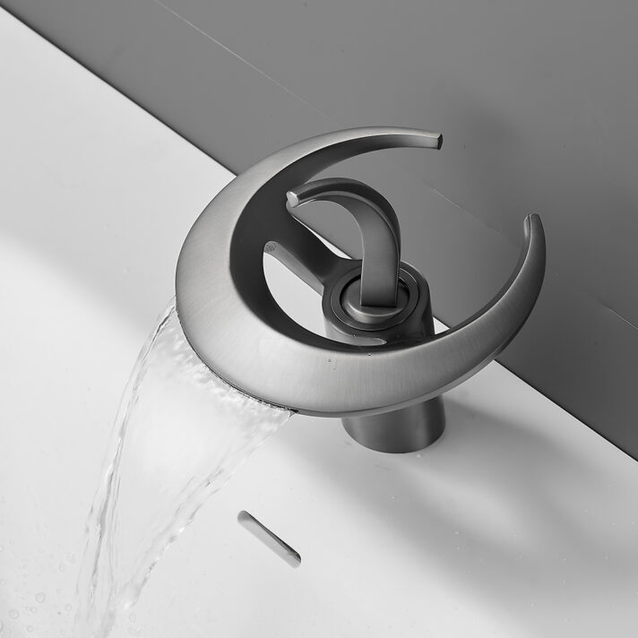 Matte Black Waterfall Bathroom Faucet with brass body and single-handle basin mixer tap featuring a curved waterfall spout, shown in brushed metallic finish