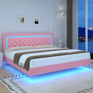 Pink floating platform bed with diamond tufted headboard and blue LED lighting along the frame, in a modern white bedroom with cityscape window view