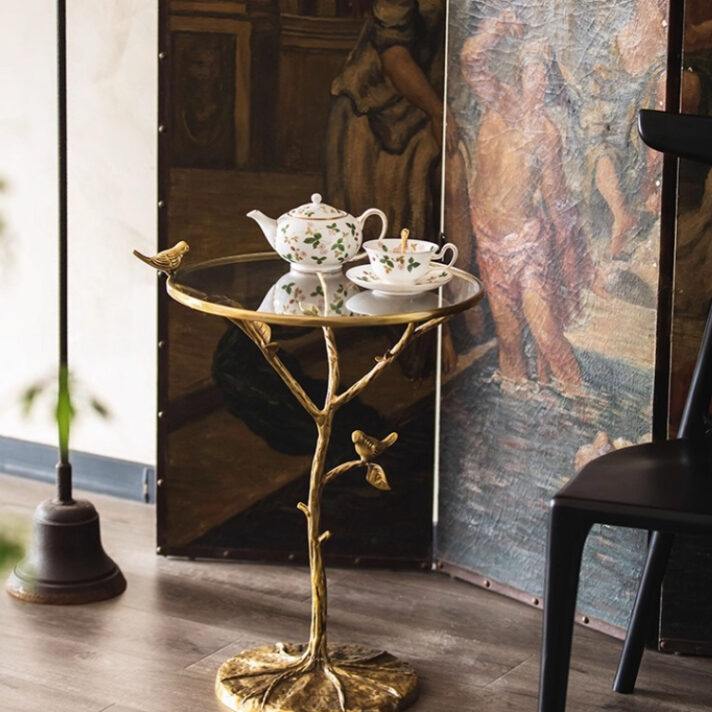 Retro Brass Bird Round Side Table featuring a brass bird pedestal and tempered glass top, showcased in a refined living space by Verra Luxe Home.