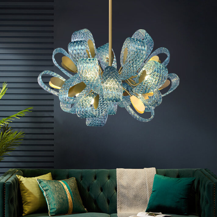 Modern blue glass LED pendant lamp with a polished gold copper frame hanging against a dark wall, adding a luxurious focal point to interiors.