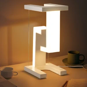 White Floating Magnetic LED Lamp on a desk with illuminated vertical panel, showcasing a modern design and subtle glow suitable for a minimalist workspace
