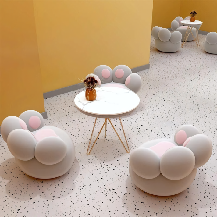 Nordic-Style Lounge Chair by Verra Luxe Home featuring a cartoon pattern, soft fabric upholstery, and plush filling in a bright showroom with yellow walls and round bubble seating.