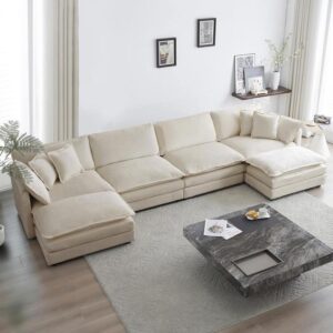 Verra Luxe Home beige modular sectional sofa in a bright living room with a large cream-beige sectional, neutral decor, and a marble coffee table.