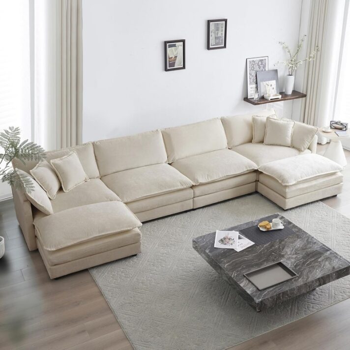 Beige 146” oversized U-shaped modular sectional sofa in camel chenille fabric with deep 25.2-inch seating, 19-inch seat height, and modular segments, placed in a bright modern living room.