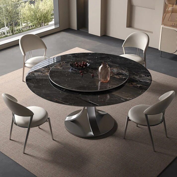 Modern Minimalist Dining Table: round black marble-top table with a sculptural pedestal base, surrounded by light gray upholstered chairs in a bright minimalist dining space, Verra Luxe Home