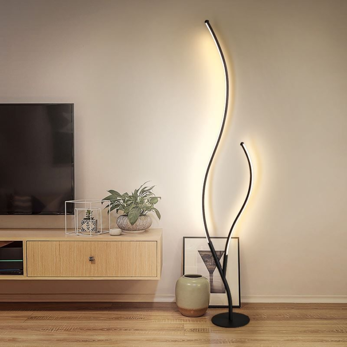 Verra Luxe Home Modern Nordic LED Floor Lamp with a black curved branch design and warm edge lighting, displayed in a minimalist living room setup