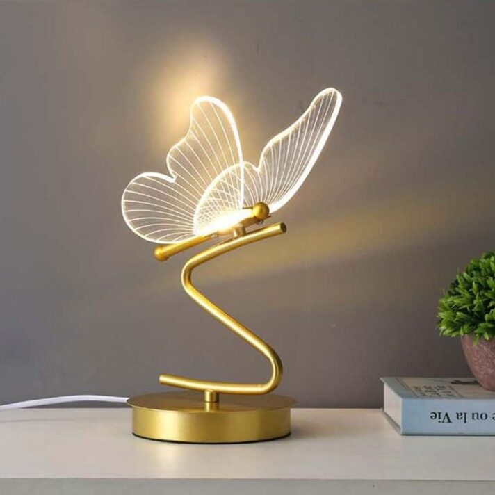 Nordic Butterfly LED Table Lamp with a gold spiral base and a transparent butterfly-shaped acrylic shade, modern lighting piece for stylish interiors.