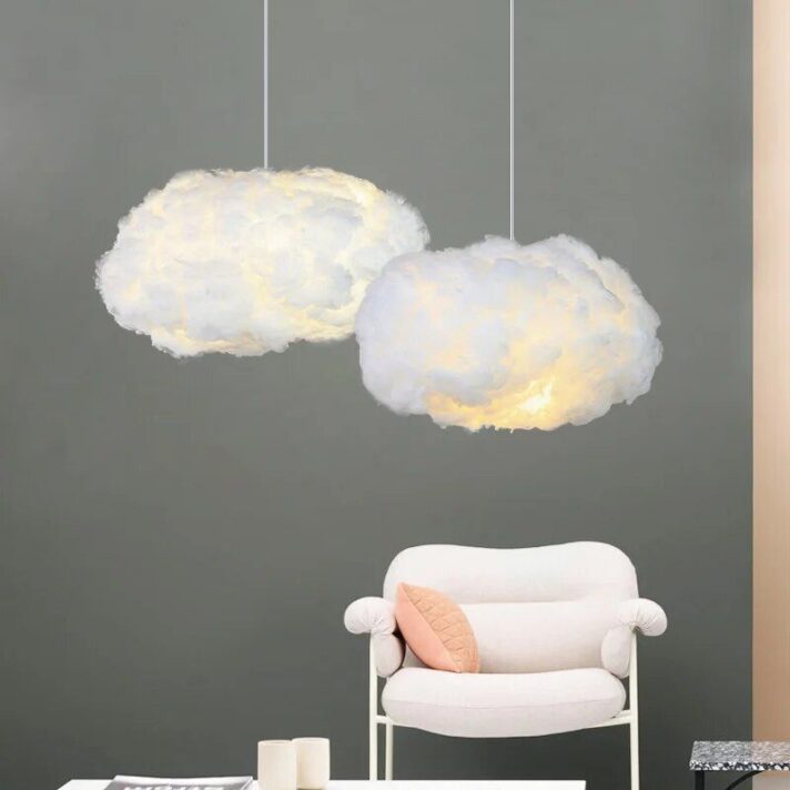 Verra Luxe Home cloud-like pendant lights with soft glow, white fluffy fixtures suspended over a white chair against a gray wall, modern luxe decor.