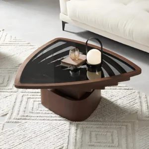 Nordic Triangle Coffee Table with black glass top and wooden base, in a modern living room beside a light-colored sofa, showcasing its triangular silhouette and sleek finish.