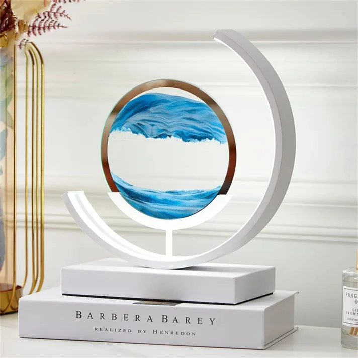 White circular sculpture lamp featuring blue wave art within a ring, a modern lighting piece by Verra Luxe Home with a minimalist base and circular frame.