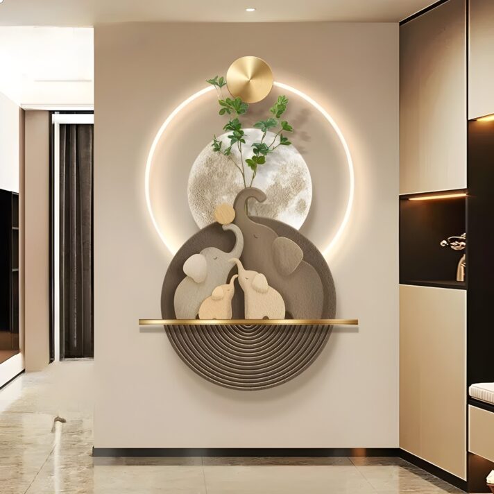 Luminous Elephant Sandstone LED Wall Art featuring layered elephant silhouettes in sandstone tones, a circular backlit halo, and gold accents set against a neutral wall