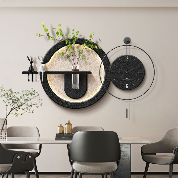 Verra Luxe Home Minimalist LED Wall Art with Clock and Green Plant Design in a black circular metal wall sculpture featuring a built-in clock and plant accent