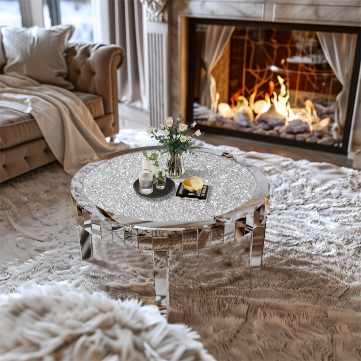 Luxurious silver mirrored round coffee table with crystal accents sits in a plush living room, featuring a shimmering reflective surface and sleek geometric legs