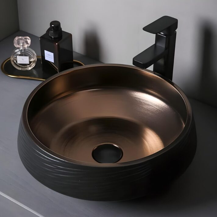 Bronze interior, round ceramic bathroom sink with black exterior and matching black faucet, part of the Deluxe Black and Bronze Ceramic Bathroom Sink Set
