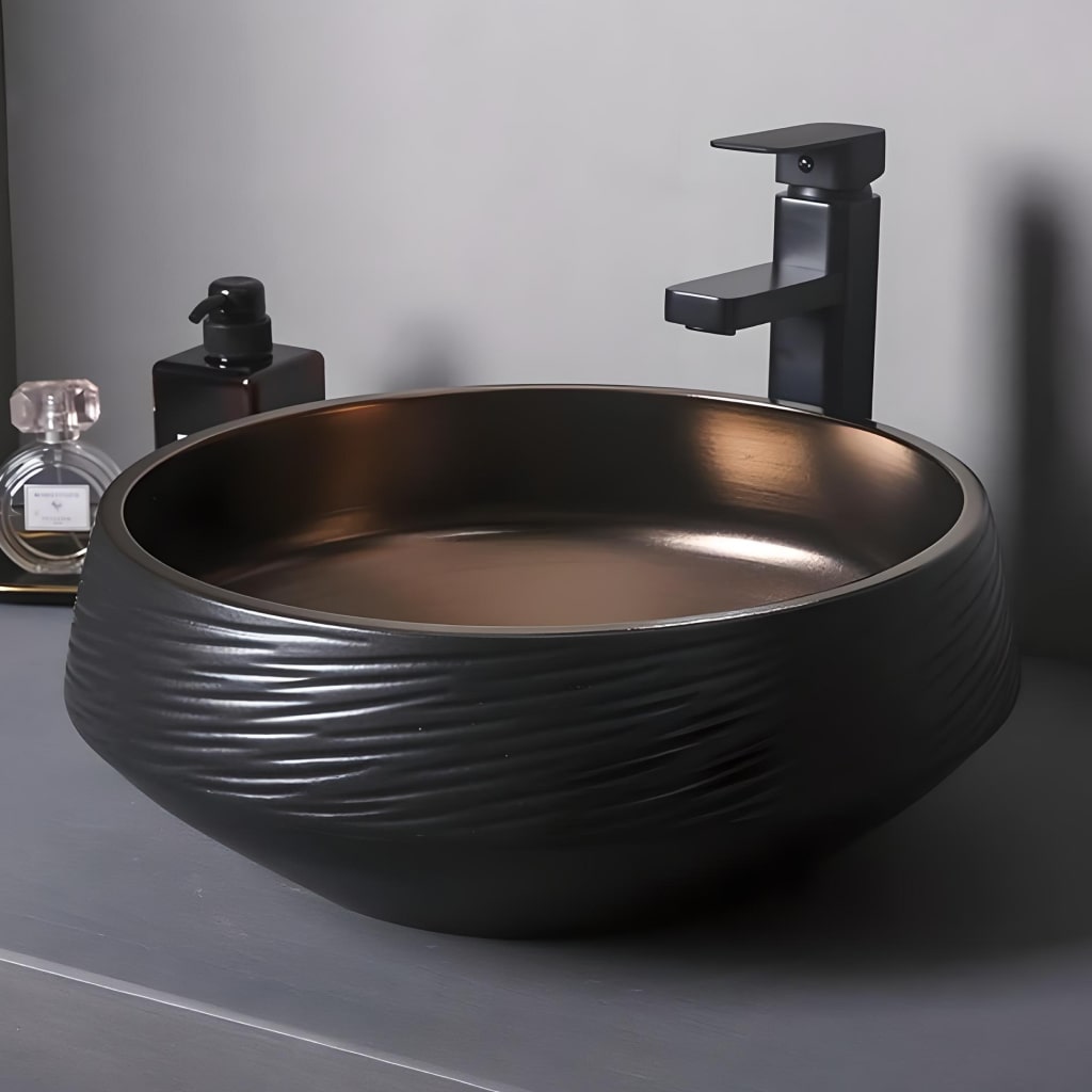 Deluxe Black and Bronze Ceramic Bathroom Sink Set featuring a round black ceramic vessel with bronze interior, a matte black faucet, and coordinated accessories.