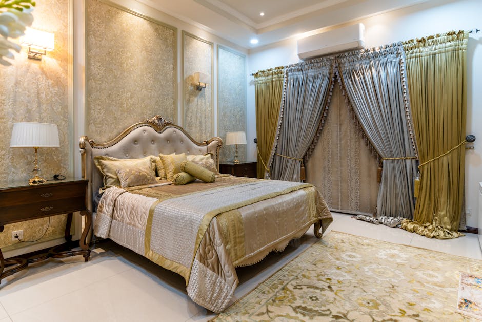 Modern Style bedroom with beige tufted upholstered bed, gold accents, textured wall panels, and olive-gold curtains in a warm neutral palette